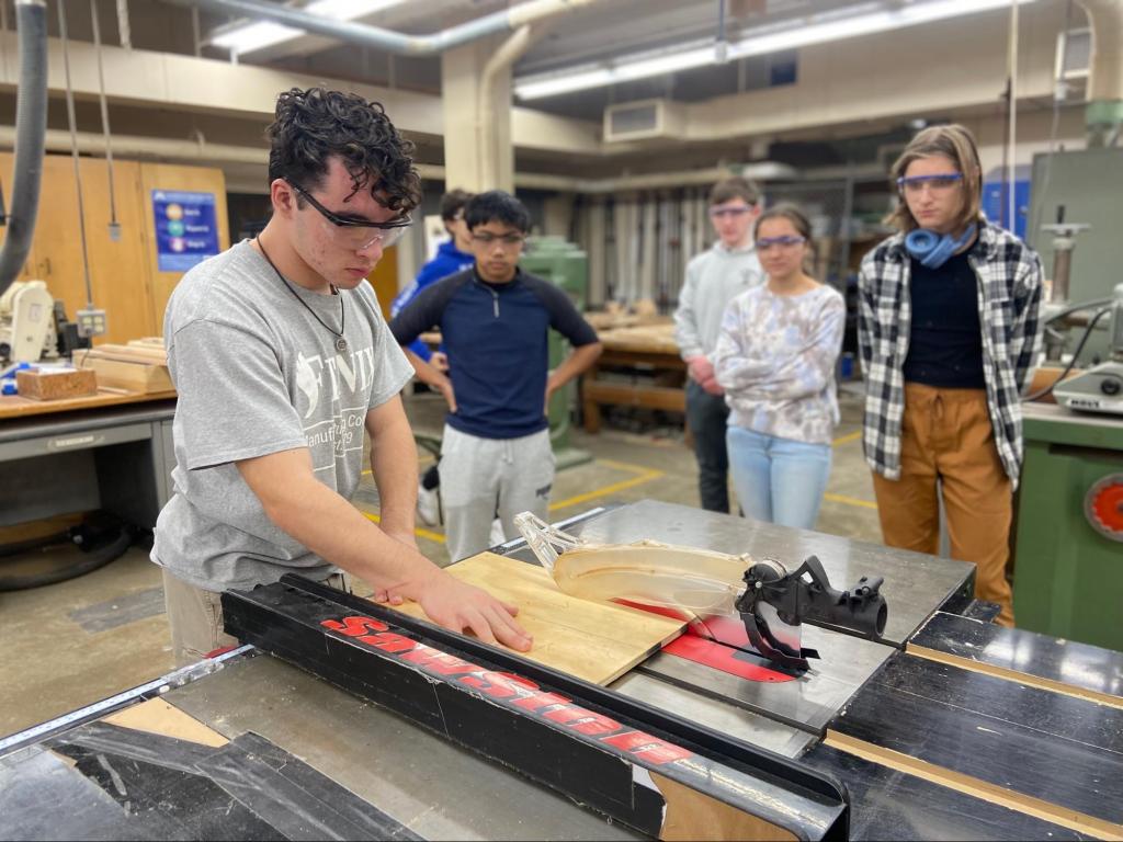 Build members doing tool training in the woodshop. The member doing the training in this photo is 